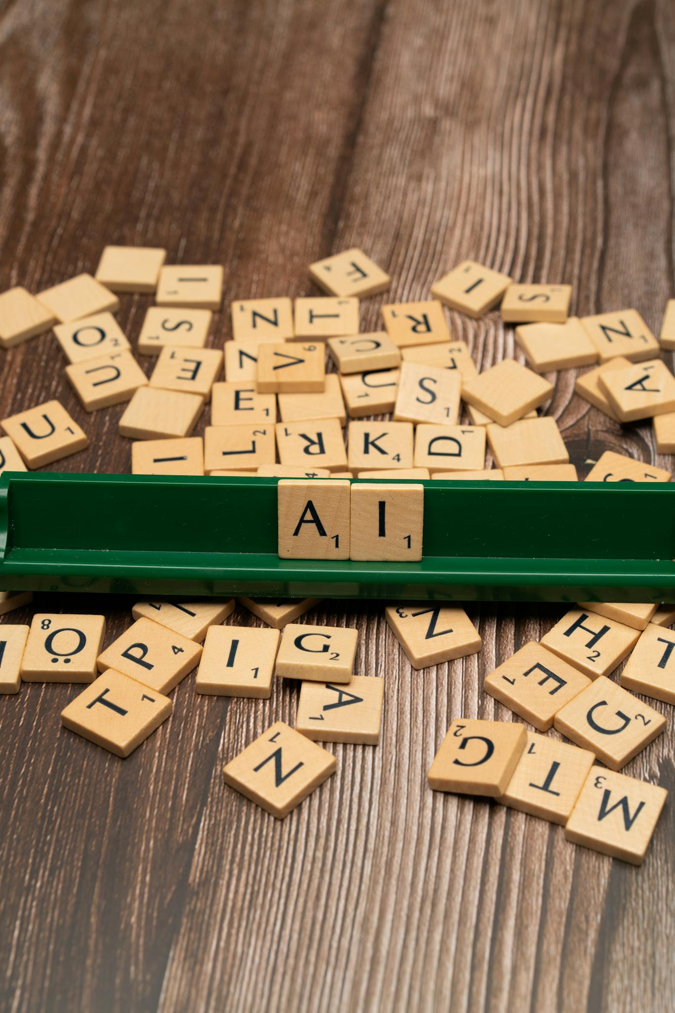 A green scrabble board with letters spelling out ai